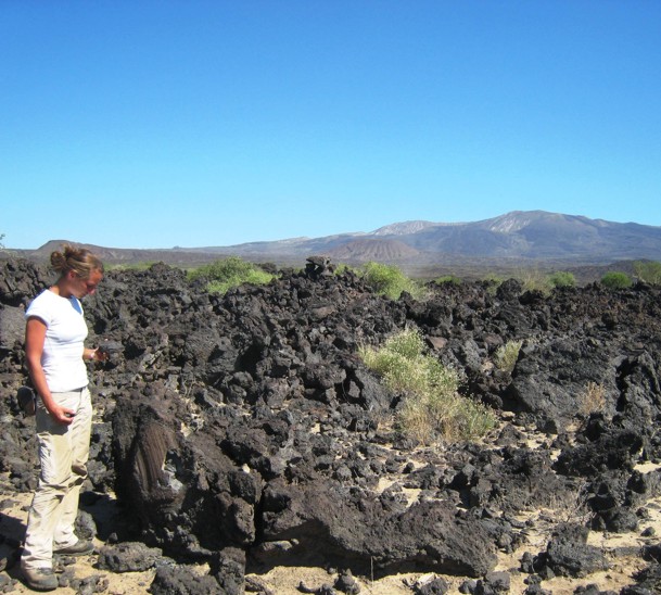 Sample collecting rift basalts with Dabbahu volcano in the background. 