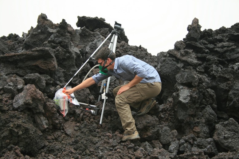 Collecting gas samples from a fissure in the new lava flow