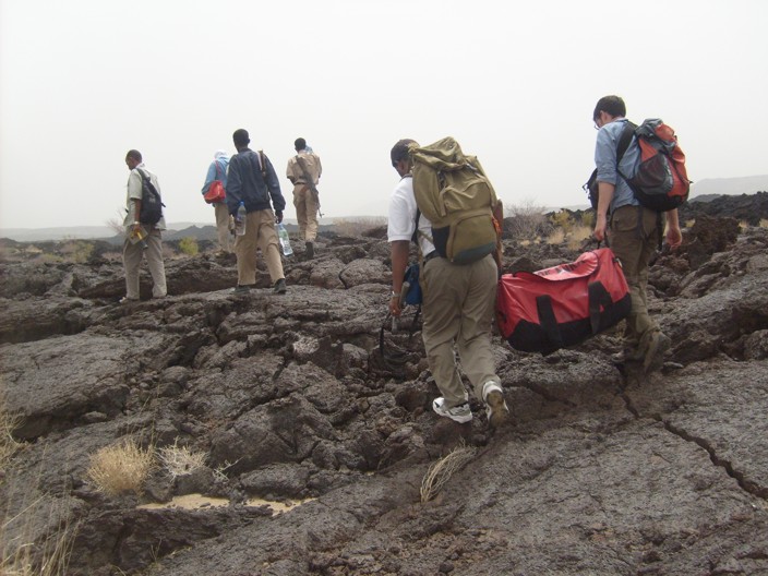 Carrying equipment from the helicopter towards the new eruption site